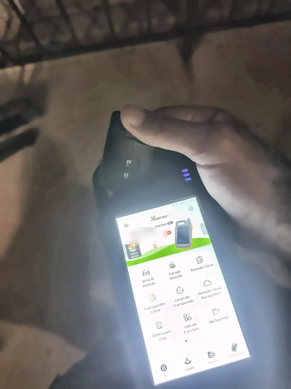 Handheld automotive key and transponder programming tool inside a vehicle